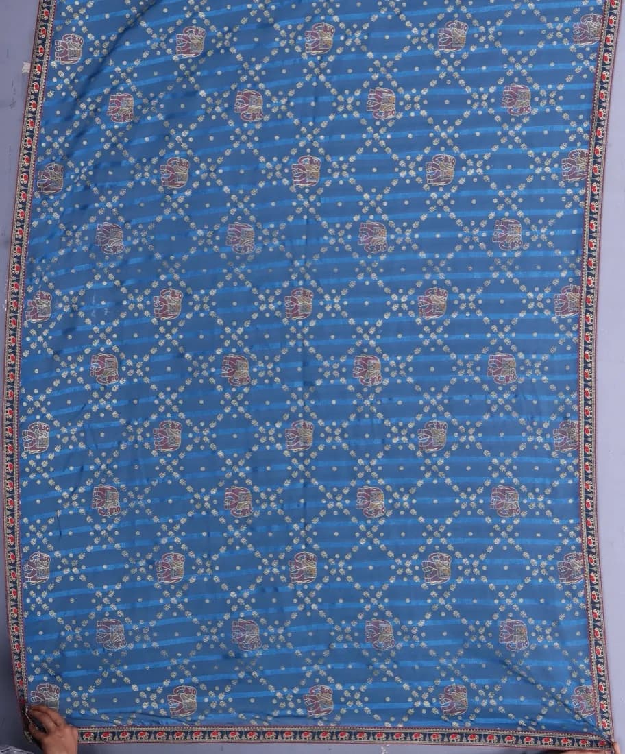 Blue bandhani saree photographed flat, the input a seller uploads